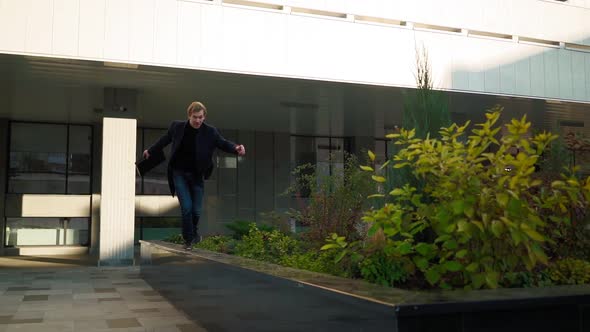 Happy Successful Business Man with Folder Documents Jumping Over an Obstacle