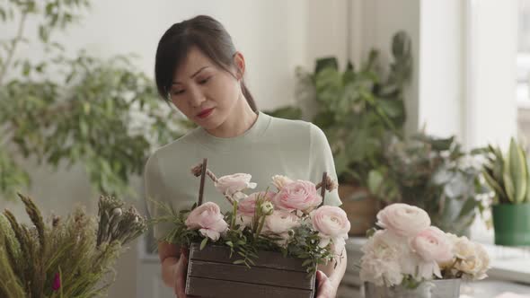 Asian Woman Posing with Flowers in Basket