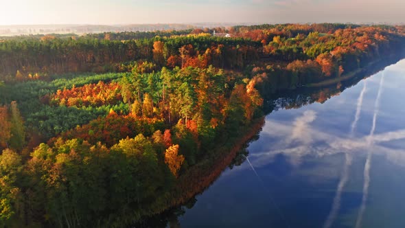 Aerial view of blue lake and autumn forest