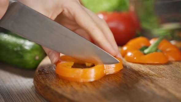 Video Close Up Cutting Orange Bell Pepper Into Small Pieces
