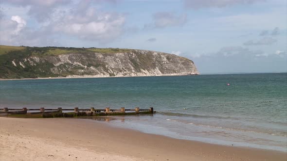 Sandy beach and white cliffs at Swanage Bay in the coastal town of Swanage in the county of Dorset i