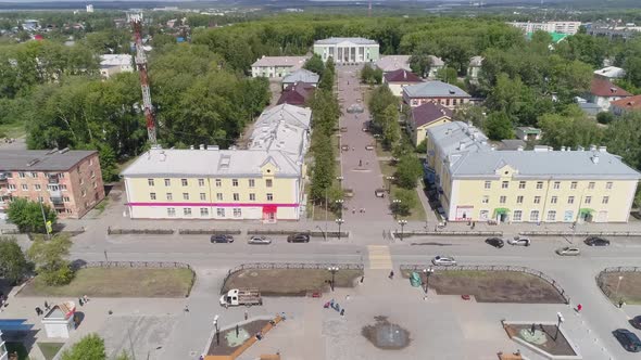 Aerial view of Square and beautiful alley. Cars drive on the roads, people walk 13