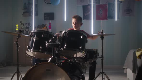 Teen Drummer Rehearsing in Bedroom