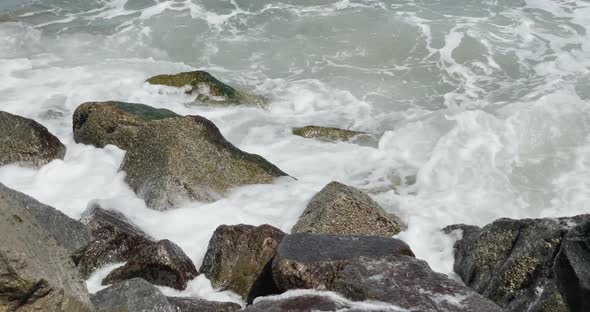 Ocean waves hitting jetty rocks