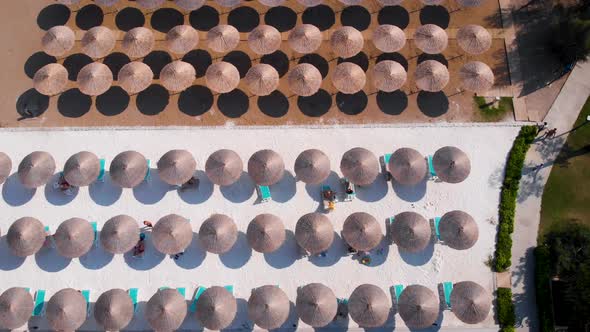 Flight Over the Beach with Umbrellas Towards the Pool in a Luxury Hotel