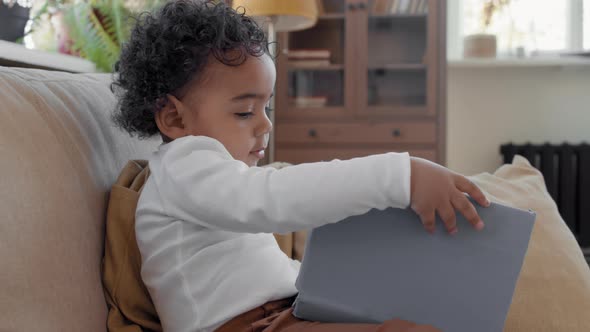 Close Up of Curious Toddler with Book alt