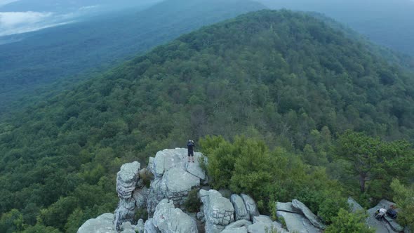 Man stands on top of Big Schloss - Virginia - Dawn - Aerial