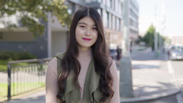 Young Asian Woman Smiles Camera Street Urban Area