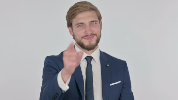 Young Businessman Pointing at the Camera on White Background