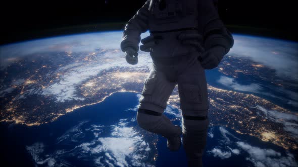 Astronaut in Outer Space Against the Backdrop of the Planet Earth alt