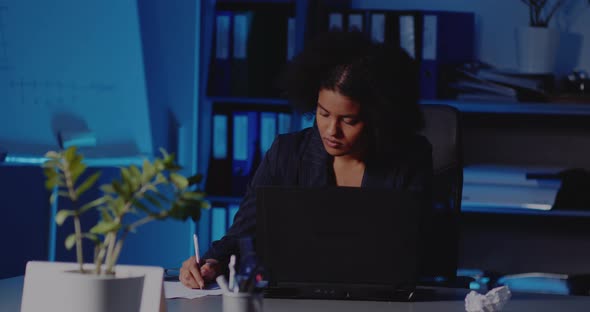 Frustrated Businesswoman Working Late in Office