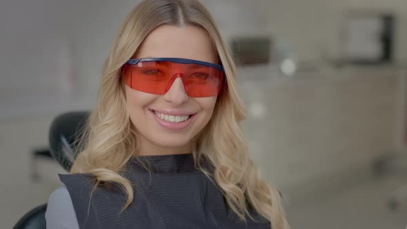 Girl Sitting In Dentists Chair And Smiling