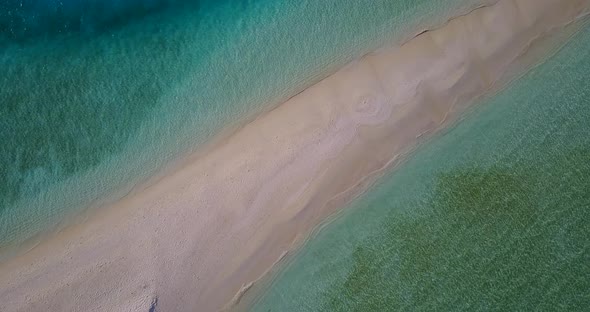 Tropical overhead copy space shot of a sandy white paradise beach and blue ocean background in high 