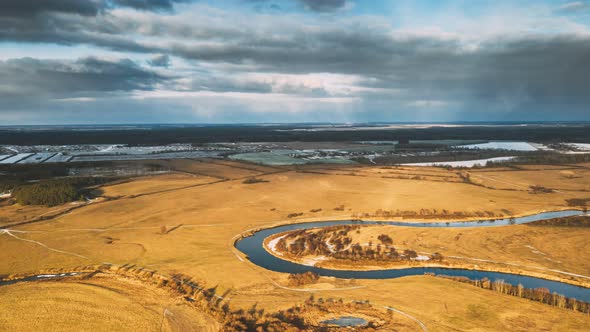 Aerial View Of Dry Meadow And Partly Frozen River Landscape In Sunny Autunn Day