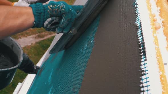 Industrial Climber Using Trowel Putty Glue on Fiberglass Mesh To Insulate Facade
