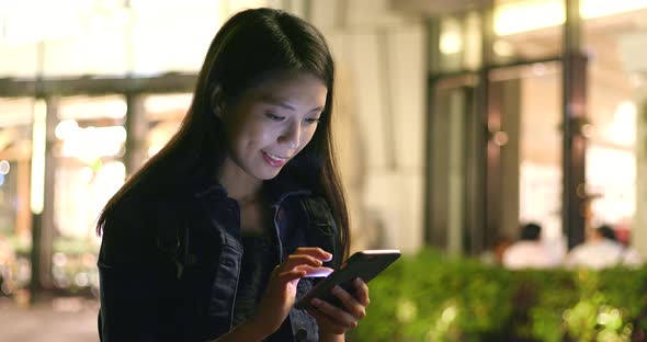 Young woman use of mobile phone in city