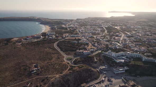 Aerial view of Sagres cityscape and coast during sunset. Establishing shot