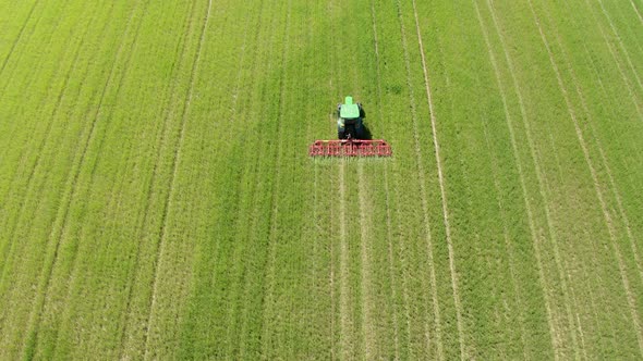 Aerial view of tractor cultivating field