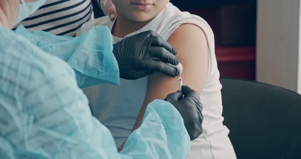 Vaccination of a Teenager in the Shoulder