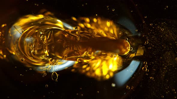 Super Slow Motion Shot of Pouring Oil Isolated on Black Background at 1000Fps