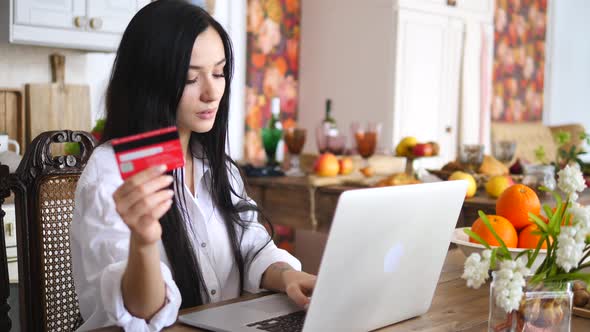 Young Woman Holding Credit Card And Using Laptop Computer. Online Shopping Concept