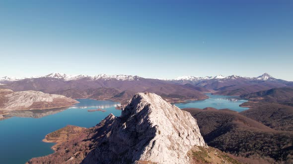Aerial shot of Pico Gilbo in León, Spain. Big mountain peak on the center of the screen. Snowy mount
