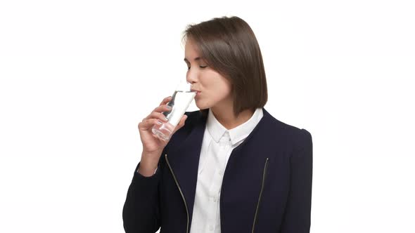 Portrait of Shorthaired Lady Wearing Business Suit Drinking Water From Glass Being Thirsty Taking