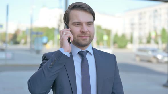 Portrait of Businessman Talking on Phone Outdoor