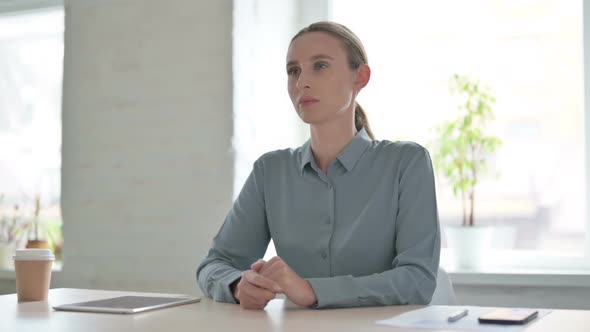 Pensive Woman Thinking While Sitting in Office