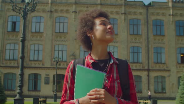 Portrait of Pretty African American Female College Student Walking After Study