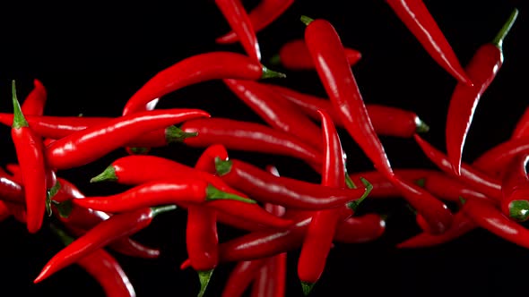 Super Slow Motion Shot of Flying Red Chilli Peppers in the Air at 1000Fps.