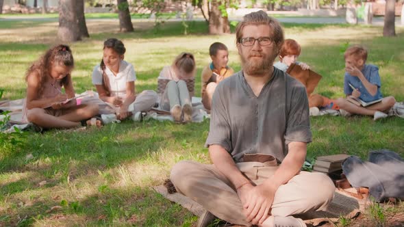 Portrait of Teacher during Outdoor Lesson in Park