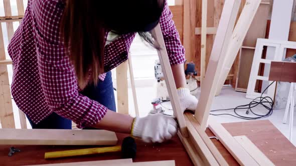 Woodwork and furniture making concept. Stylish craftswoman working in carpentry