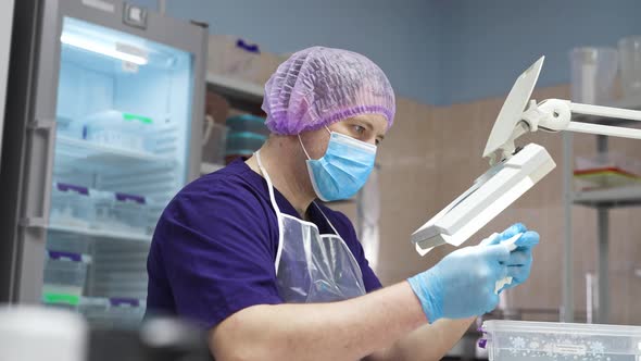 A Laboratory Worker Checks the Condition of the Samples Before Testing