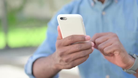 Close Up of African Man Using Smartphone