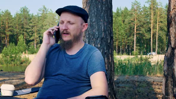 A Man is Resting in a Forest in a Unique Place in an Ecologically Clean Area