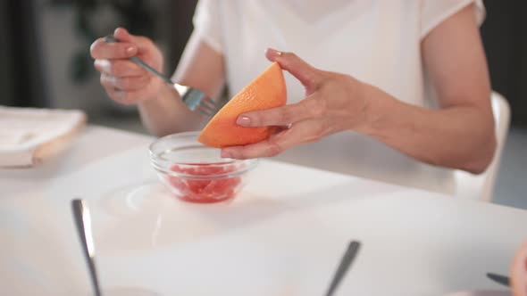 Unrecognizable Woman Making Grapefruit Scrub