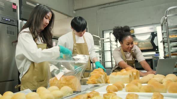 Three young startup partners taking online orders, pastry, and bakery food shop.