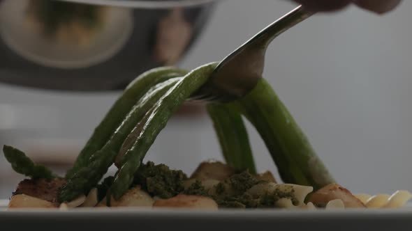 Slow Motion Closeup Put Asparagus Over Scallops on Fusilli Pasta