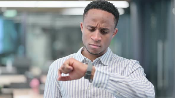 African Businessman Watching Smart Watch Waiting