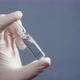 A Hand in a Medical Glove Holds and Shows the Ampoule - VideoHive Item for Sale