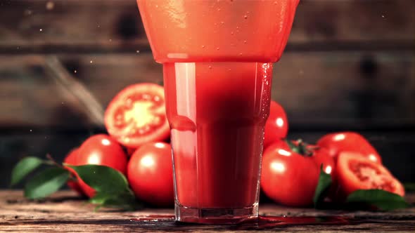 Super Slow Motion in a Glass with Tomato Juice Drops Tomato with Spray