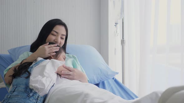 Asian daughter vising sick mother who admited and on IV