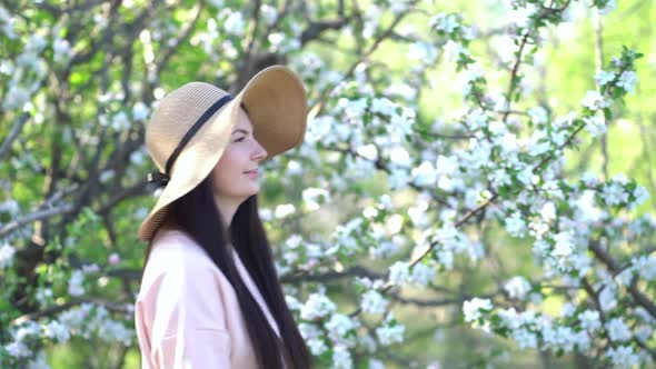 Beauty Young Woman Enjoying Apple Blooming Spring Orchard.