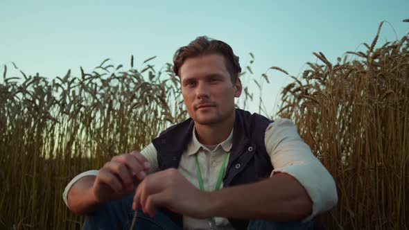 Portrait Serious Farmer Posing at Cultivated Wheat Field