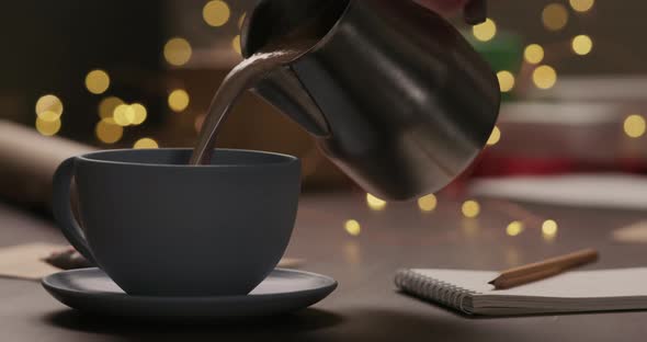 Slow Motion Man Pour Hot Chocolate in Blue Cup in the Evening with Shopping List for Holidays in