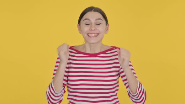 Spanish Woman Feeling Cold on Yellow Background