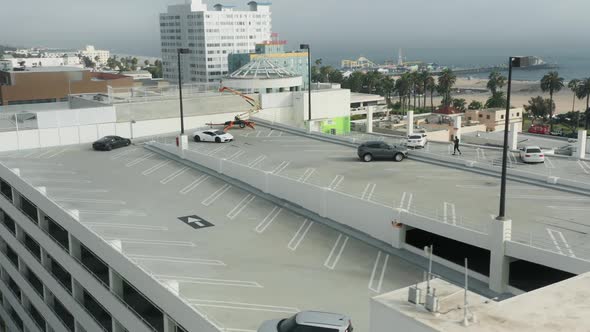 Aerial Two Exotic Sports Cars Parking on Top Level Parking Garage Santa Monica