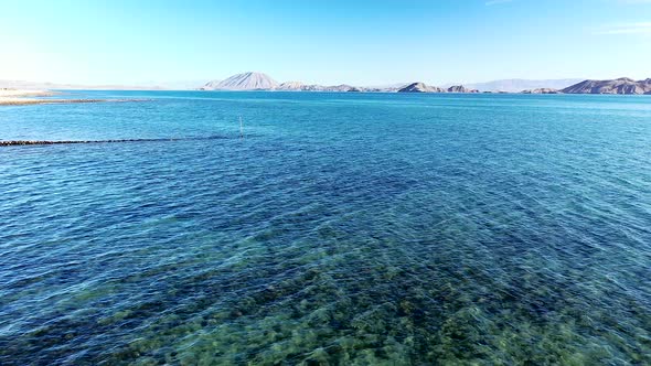 Rippling Blue Ocean On A Sunny Day In Bahia de los Angeles, Baja California, Mexico. wide aerial sho