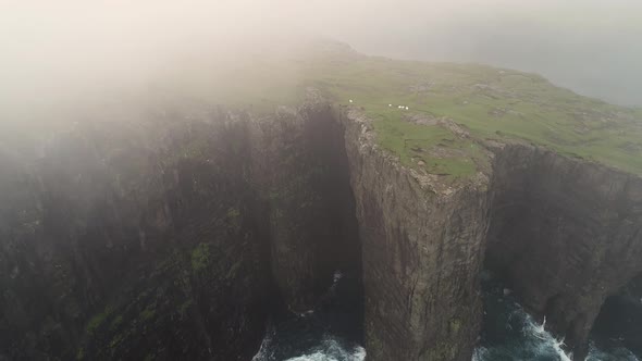 Aerial view of foggy covering English Slave cliff, Faroe island.